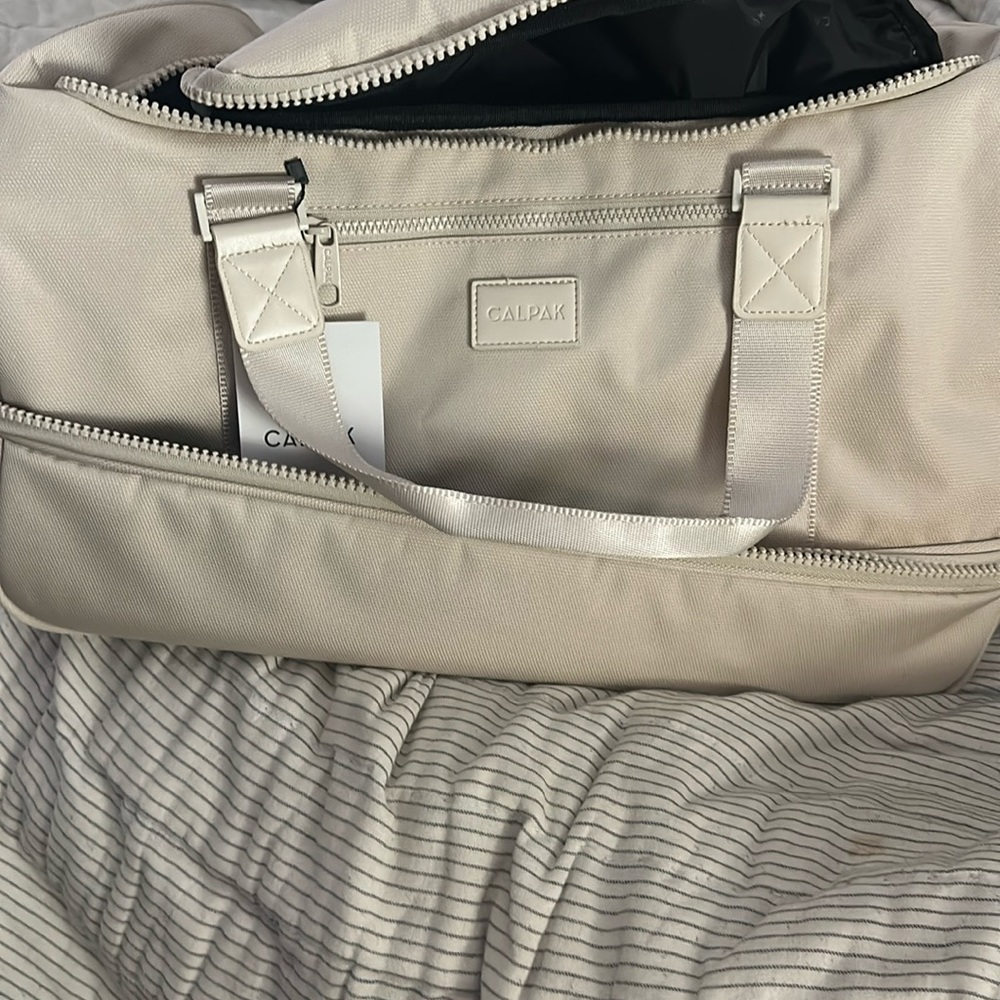 Brand new with tags Calpak Stevyn Duffel Bag with Shoe Compartment. Color Dune.